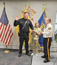 <b>Detective Corporal Louis Cataldo takes the oath of office as he is promoted to sergeant in the Sussex County Sheriff’s Office. At right is Sheriff Michael Strada. (Photos provided)</b>