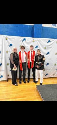 From left are Kathleen Smart, Thomas Smart, Joseph Smart and Staff Sgt. Escobar Lance. The twins graduated from Pope John XXIII Regional High School on Tuesday, June 3. Each has signed with the U.S. Marine Corps and will be leaving for training at Parris Island, S.C., this summer. (Photo provided)