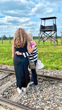 Mary Houghtaling visits the site of the Auschwitz-Birkenau concentration camp with Maude Dahme, a Holocaust survivor. (Photo provided)