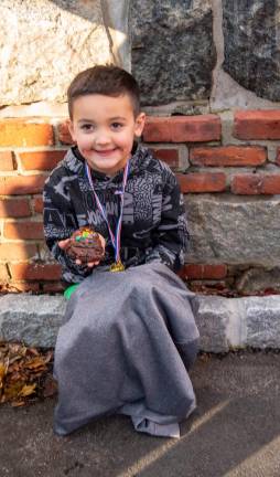 Bode Bagley holds a cookie after the Fun Run.