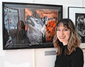 Megan Mahfoud with her photo ‘Wolf vs. Spider,’ which won Best in Show in the 10th annual Xpose exhibition. (Photos by Nancy Madacsi)