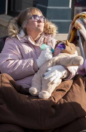 Bobby Jo Applegate of Newton feeds granddaughter Brittany Matlock, 2 months, of Newton. Brittany's big sister was marching with the Newton High School Marching Band.