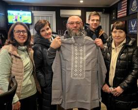 Sparta VFW Commander Peter Litchfield displays a Ukrainian garment presented to him by local Ukrainians. (Photo courtesy of Sparta VFW)