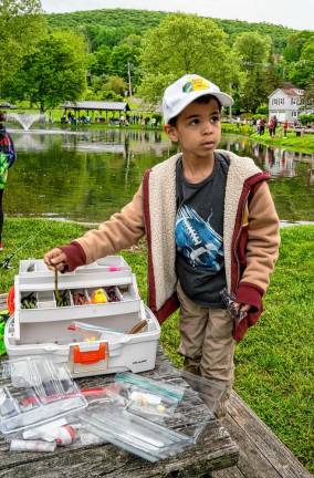 Odin Carmichael takes bait from the box.