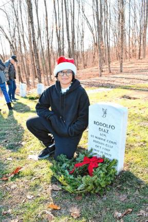 Chase Diaz poses next to the grave of his father, Rodolfo. (Photo by Maria Kovic)