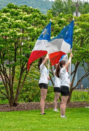 Girls hold flags during the ceremony.