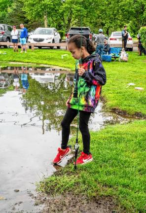 Juliet Carmichael checks the depth of the pond.