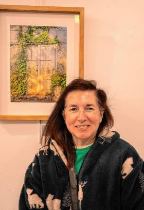 Elaine Norman in front of her photo ‘Entranced,’ which won the Cityscape/Architecture Award.