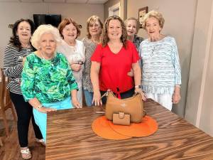 Members of the Sparta Woman’s Club with a Coach purse and wallet that will be a raffle prize at the annual Game Day &amp; Luncheon fundraiser Wednesday, Oct. 16. (Photo provided)