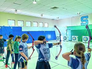 The archery team at Helen Morgan School practices. (Photos by Olivia Flanz)