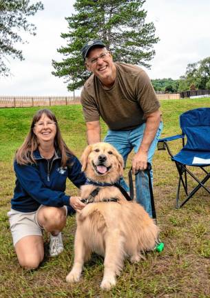 Tara and Chris Perretta with Mikey, a Golden Retriever.