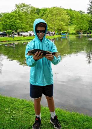 Matthew Paterson holds a large mouth bass he caught.