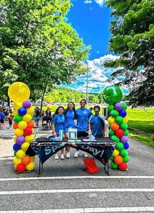 Members of the Junior Woman’s Club of Sparta greet visitors at the entrance to Sparta Day 2024. (Photo by Olivia Flanz)