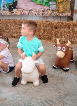 <b>Wesson Wilpelt sits on a toy cow. (Photo by Nancy Madacsi)</b>