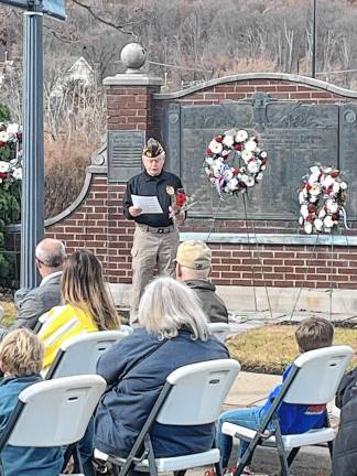 Veteran Jerry Murphy speaks in front of the memorial, where wreaths were placed during the Veterans Day ceremony Monday, Nov. 11 in Sparta. (Photo by Dave Smith)