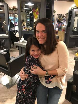 Sadie Brand with her third grade teacher, Courtney Petermann. Brand followed in Petermann's footsteps and donated her hair for wigs to go to those with cancer.