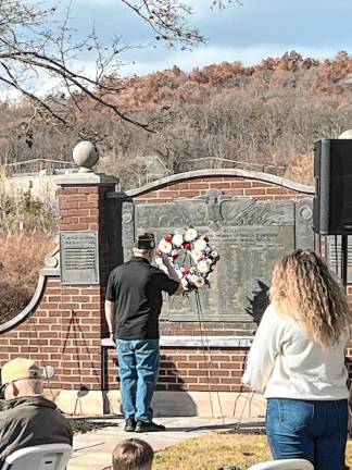 A veteran salutes in front of a wreath at the memorial during the Veterans Day ceremony Monday, Nov. 11 in Sparta. (Photos by Dave Smith)