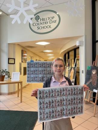 Isabeau with her artwork printed as wrapping paper in <i>Sparta Independent</i> last year. Photo provided.