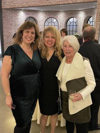 SCCC board members Candice Smith, left, and Maryanne Fox, right, stand with Heidi Weber, SCCC Foundation board member.