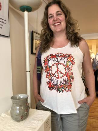 Wendy Ransom, who teaches art to grades preK-8 at Ogdensburg Elementary School, poses by a vase she made.