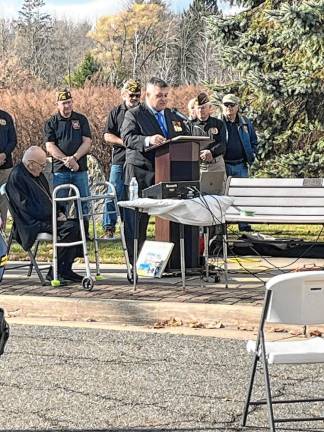 Veteran Angel Diaz Jr. reads an essay written by his daughter, a student at Pope John. Diaz was a former U.S. Marine Corps infantry sergeant and a M47 Dragon anti-tank missile gunner in both Beirut and Grenada.