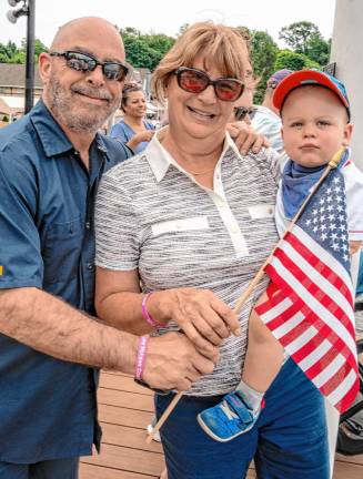 Andrew Denka with his wife, Lynn, and grandson Aaron at the parade. Denka is a powerboat and automobile racer.