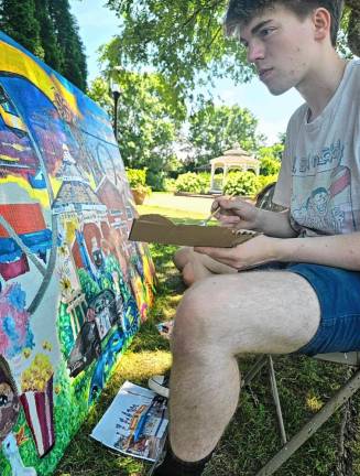 <b>High Point Regional High School graduate Marvin LiTrenta works on the mural.</b>