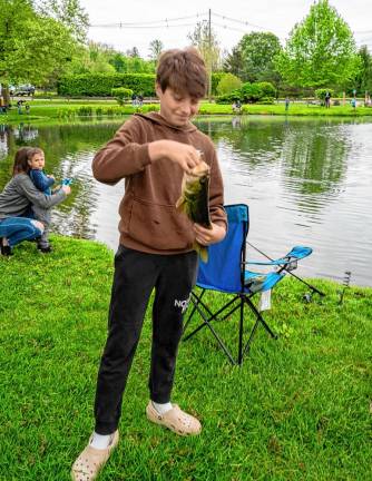 Davin Picinit holds a bass he caught.