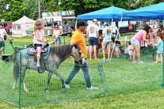 A girl takes a pony ride during the Sparta Food Truck &amp; Music Fest on Saturday, July 20 at White Lake Park. (Photos by Maria Kovic)