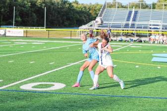 GS1 Sparta's Mya Grycuk, left, and Chatham's Ava Paone jostle while trying to get positioned beneath the ball. The Spartans won, 2-1, in overtime Sept. 16. (Photos by George Leroy Hunter)