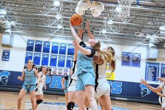 SB1 Sparta's Molly Chapman, foreground, lifts the ball toward the hoop during a game against River Dell on Jan. 30. The Spartans won, 51-46, and Chapman scored nine points. (Photos by George Leroy Hunter)