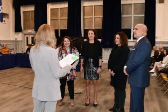 From left, Emily “Ramos” Serafino, Rebecca Williams, Michelle Hinkle and Roque Martinez are sworn in to seats on the Board of Education at the annual reorganization meeting Jan. 6. (Photo by Maria Kovic)