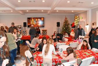 Residents gather at Frankie’s Christmas Spectacular on Dec. 15 at Veterans of Foreign Wars Post #7248 in Sparta. The event collected toys for patients at Children’s Hospital of Philadelphia and Ronald McDonald House. (Photo by Maria Kovic)