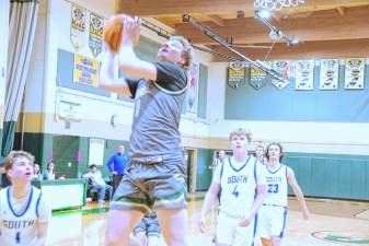 ST1 Sussex Tech's Brian Gruber rises toward the net during a shot in the fourth quarter of the game against South Hunterdon on Jan. 4. South Hunterdon won, 76-51, and Gruber scored 21 points. (Photos by George Leroy Hunter)