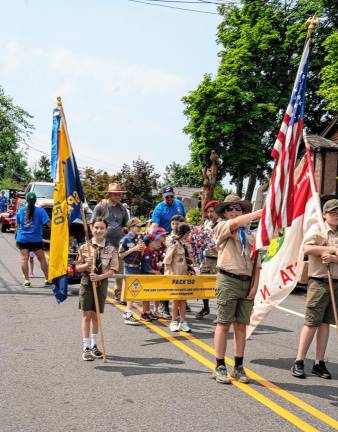 Members of Boy Scout Troop 150 march in the parade.