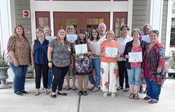 <b>Recent graduates of the International Doula Life Movement (IDLM) certification program hold certificates at a recent graduation ceremony at the Karen Ann Quinlan Home for Hospice in Fredon. From left are Lisa O’Hara, president of Friends of Karen Ann Quinlan Hospice; Mary Ellen Quinlan, chairwoman of the Karen Ann Quinlan Memorial Foundation; Barbara Steen, an end-of-life doula (EOLD); Anna Adams, founder of IDLM; EOLDs Dawn Harris, Debra Walck, Carol Cummins, Brian Cummins, Kim Germain, Dawn Bump, Barbara Palumbo and Lee Ellison; and Pamela Carter, executive director of IDLM. (Photo provided)</b>