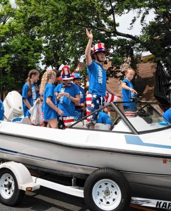 Members of the Lake Mohawk Ski Hawks ride in the parade.