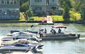 Emergency crews search Greenwood Lake Monday morning for the body of a Chestnut Ridge man.