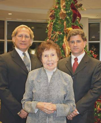 From left, Louis Ruggiero, president of Iliff-Ruggiero Funeral Home; Julia Quinlan, co-founder and president of Karen Ann Quinlan Hospice; and Domenick Ruggiero, manager of Iliff-Ruggiero Funeral Home gather at a former Lights of Life Tree Lighting Memorial Service at Sussex County Community College to embrace area families with this thoughtful holiday tradition.