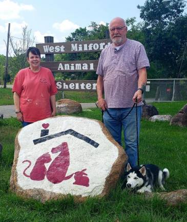 Paula Whritenour, secretary, and Paul Laycox, president of West Milford Animal Shelter Society, pose with Nova, a young Huskie who is ready for a new home.