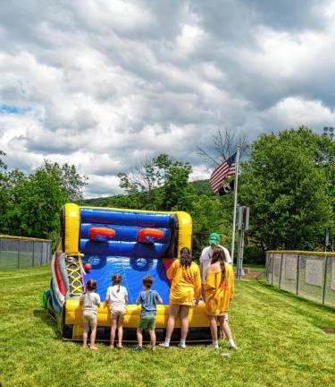 Children play basketball at this inflatable game. (Photo by Nancy Madacsi)