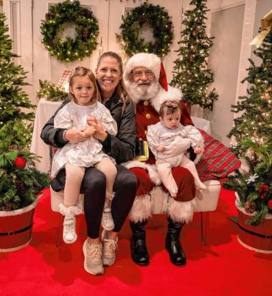 Brooke, Brianna and Emma Reigstad pose with Santa.