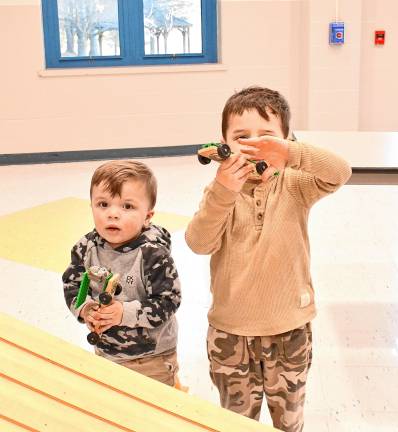 Logan and Lucas Zapata of Sparta hold Pinewood Derby cars.