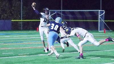 Jefferson quarterback Erik Garv is in the midst of throwing the ball while under pressure by Sparta defenders in the second quarter (George Leroy Hunter)