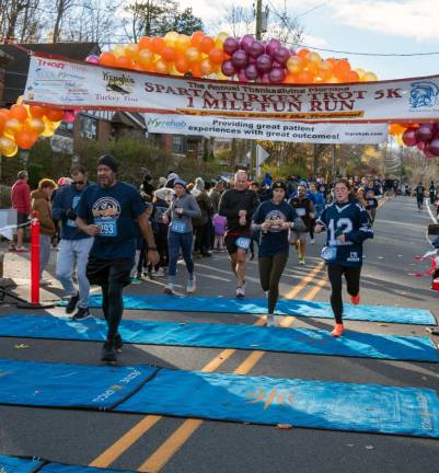 5K runners cross the finish line.