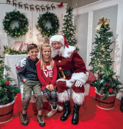 Leo and Camille Sherman pose with Santa at the Lake Mohawk Country Club.