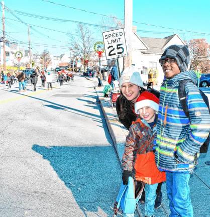 Kaylee Ryan, Noah Vargas and Sebastian Nazaire watch the parade.