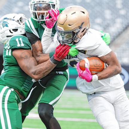 Pope John’s Tylik Hill tries to fight off two DePaul defenders on a run.