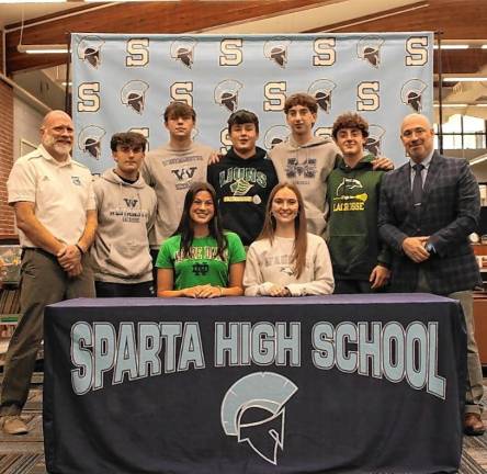 Seven Sparta High School athletes committed to their future colleges on National Signing Day on Thursday, Nov. 14. Seated from left are Uma Kowalski and Abigail Connors. Standing from left are athletic director Steven Stoner, Adam Teixeira, Matthew Peters, Sebastian Sakowski, Christian Hantson, Matthew Ciarelli and Principal Ed Lazarra. (Photo provided)