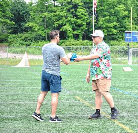 A player hands the bags to another. (Photos by Fred Ashplant)